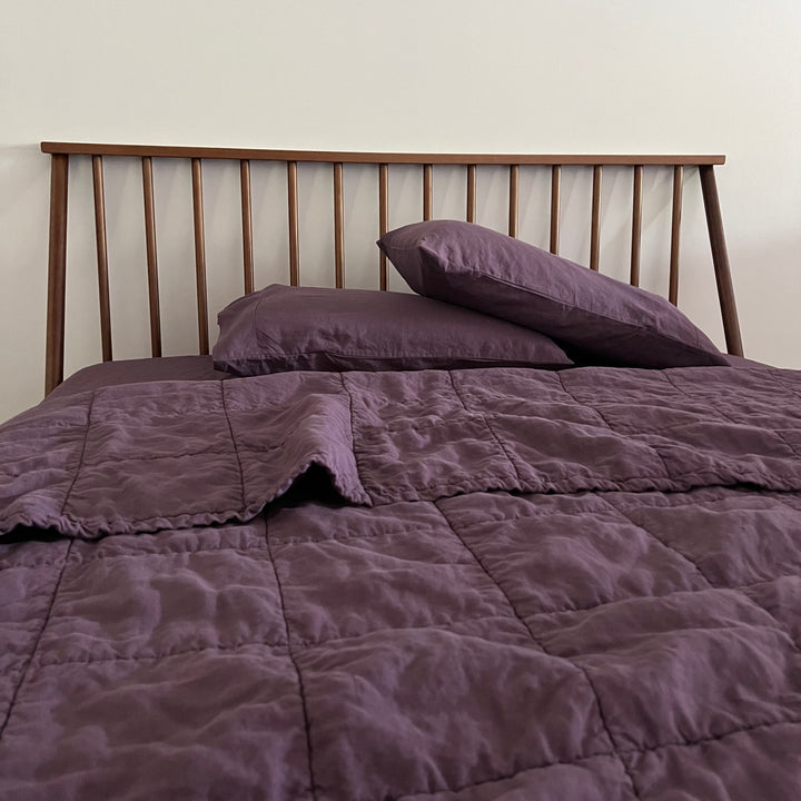 shaker bed with purple quilt